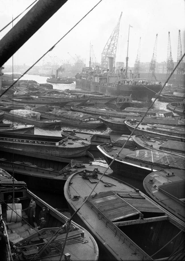 Historical view across the River Thames and working docks around Wapping.