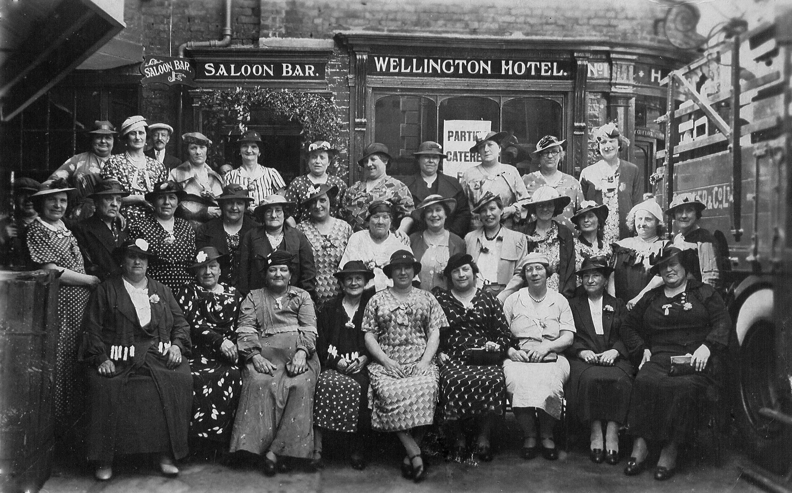 Historical group photograph of women gathered outside a public house.
